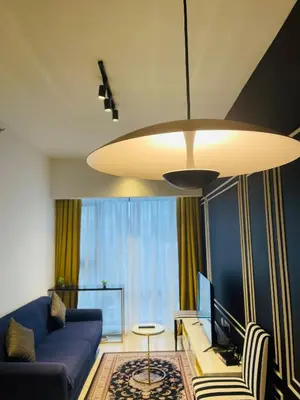 a living room with a blue couch and a television at Axon Suite Premium KL in Kuala Lumpur
