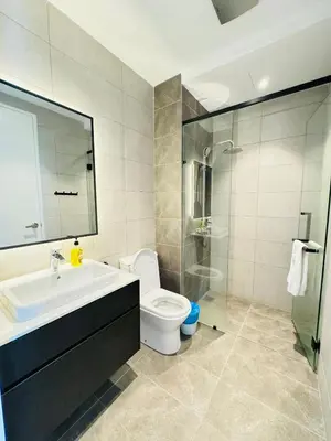 a bathroom with a sink and a toilet and a shower at Axon Suite Premium KL in Kuala Lumpur