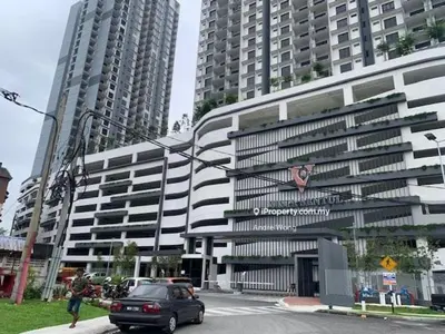 a car parked in front of a building with tall buildings at vista sentul residence share apartment with host in Kuala Lumpur