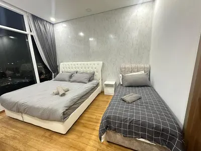 a bedroom with two beds and a window at 2bedroom SOHO SUITE KLCC View by Homeizing in Kuala Lumpur