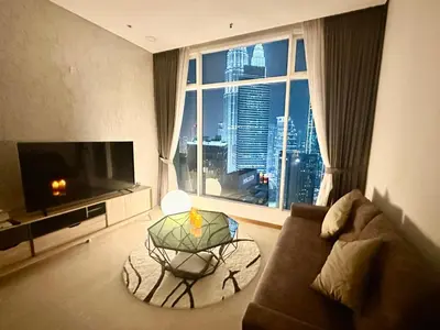 a living room with a couch and a large window at 2bedroom SOHO SUITE KLCC View by Homeizing in Kuala Lumpur