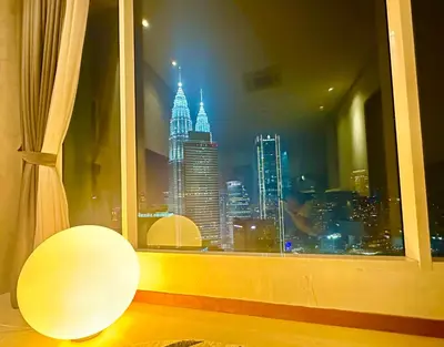 a window with a view of the empire state building at 2bedroom SOHO SUITE KLCC View by Homeizing in Kuala Lumpur
