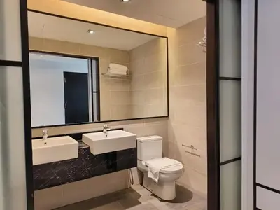 a bathroom with a sink and a toilet and a mirror at Suites at Maison 101,Heart Of KL City in Kuala Lumpur