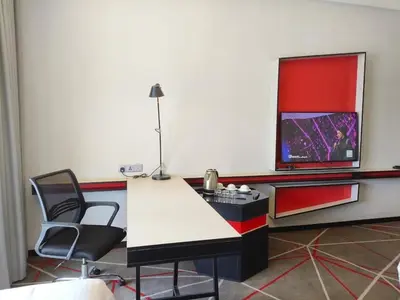 a room with a desk and a tv on a wall at Suites at Maison 101,Heart Of KL City in Kuala Lumpur