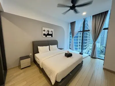 a bedroom with a bed and a ceiling fan at Eaton Residence KLCC By HM Costa Doro in Kuala Lumpur
