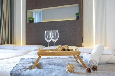 a table with two wine glasses on a bed at Urban KL Gem Perfect Getaway High Speed 100Mbps in Kuala Lumpur