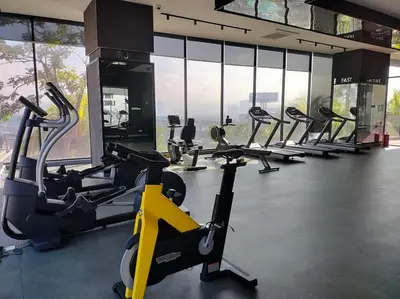 a gym with rows of treadmills and cardio machines at Exquisite KL Retreat Pool & Gym High Speed 100MB in Kuala Lumpur