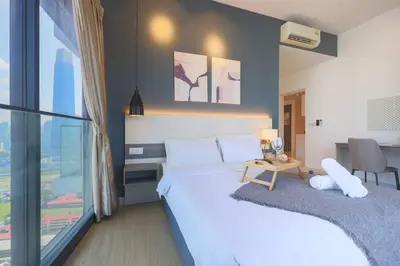 a bedroom with two beds and a table with a desk at Continew TRX Corner House +2 Balconies +2 Rooms in Kuala Lumpur