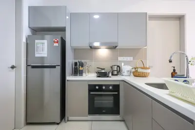 a kitchen with a refrigerator and a sink at Conveniently Located Trion KL Premium Amenities in Kuala Lumpur