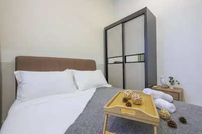 a bedroom with a large bed with a tray on it at Conveniently Located Trion KL Premium Amenities in Kuala Lumpur