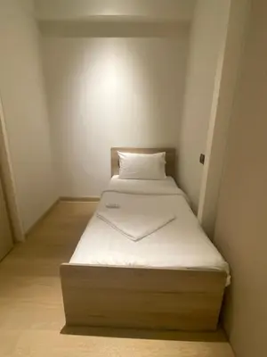 a small bed in a small room at Eastern Suites Star KLcc in Kuala Lumpur