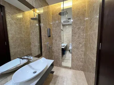 a bathroom with a sink and a shower with a mirror at The Dorsett Residence Service Suite Bukit Bintang KL in Kuala Lumpur