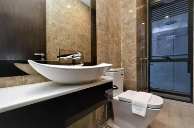 a bathroom with a sink and a toilet at The Dorsett Residence Service Suite Bukit Bintang KL in Kuala Lumpur