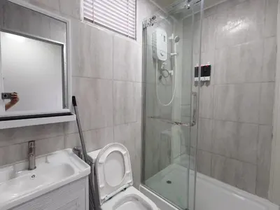 a bathroom with a shower and a toilet and a sink at Titiwangsa Cabin Retreats by uBook in Kuala Lumpur