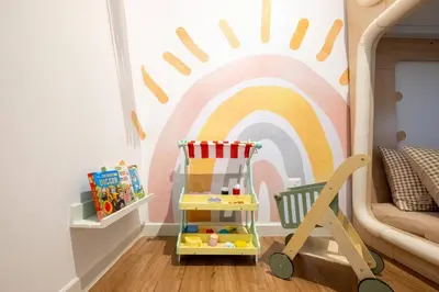 a childs room with a rainbow mural on the wall at M Vertica KL City Tower C By Feel Home in Kuala Lumpur