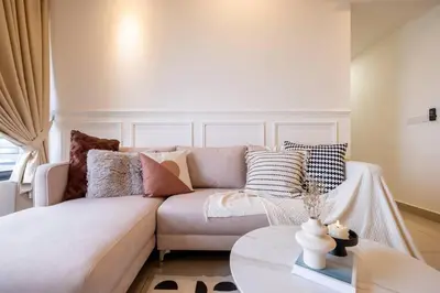 a living room with a white couch and a table at M Vertica KL City Tower C By Feel Home in Kuala Lumpur