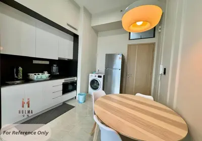 a kitchen with a wooden table and a refrigerator at The Colony BEST SKY Pool View in Kuala Lumpur