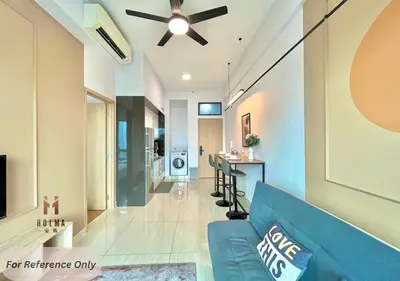 a living room with a blue couch and a table at The Colony BEST SKY Pool View in Kuala Lumpur