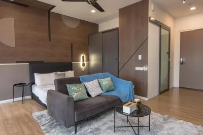 a living room with a couch and a bed at Ceylonz Suites near KLCC& KL Tower by My Trip & My Stay in Kuala Lumpur