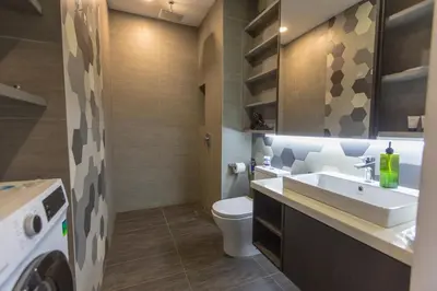a bathroom with a sink and a toilet at Ceylonz Suites near KLCC& KL Tower by My Trip & My Stay in Kuala Lumpur