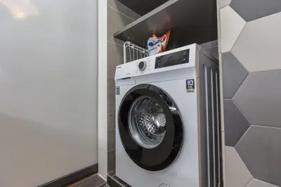 a washing machine in a room with a wall at Ceylonz Suites near KLCC& KL Tower by My Trip & My Stay in Kuala Lumpur
