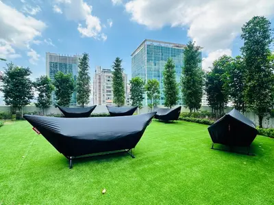 a group of chairs sitting on a field of grass at Agile Bukit Bintang Suites TRX in Kuala Lumpur