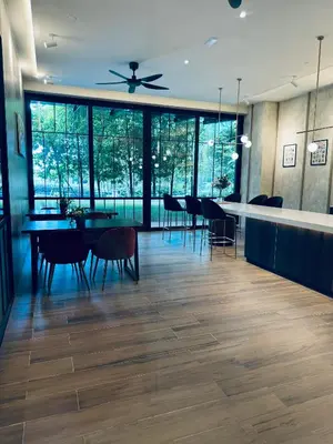 a dining room with a table and chairs and windows at Agile Bukit Bintang Suites TRX in Kuala Lumpur