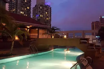 a swimming pool in the middle of a city at night at 19-16 Casa Mutiara-Sweet Home city view in Kuala Lumpur