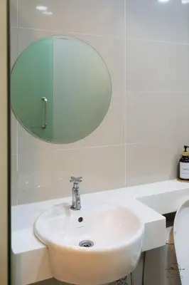 a white bathroom with a sink and a mirror at Scott Garden #23th KLCC view #MidValley Megamall in Kuala Lumpur