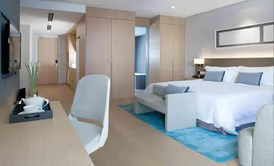 a bedroom with a bed and a couch and a chair at 188 Suites KLCC by Premium Suites in Kuala Lumpur