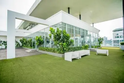 a large glass building with a tree in front of it at 188 Suites KLCC by Premium Suites in Kuala Lumpur