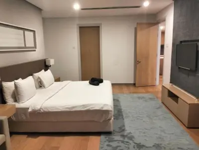 a bedroom with a bed and a flat screen tv at 188 Suites KLCC by Premium Suites in Kuala Lumpur