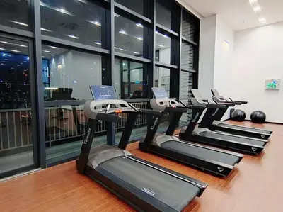 a row of treadmills in a gym with windows at Chambers Residence by Manhattan Group in Kuala Lumpur