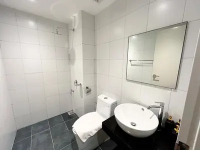 a bathroom with a white toilet and a sink at Chambers Residence by Manhattan Group in Kuala Lumpur