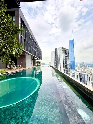 a swimming pool on the roof of a building with a city at Luxurious Home Smart service Lucentia residence in Kuala Lumpur