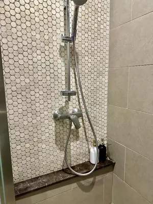 a shower in a bathroom with a shower head at Luxurious Home Smart service Lucentia residence in Kuala Lumpur