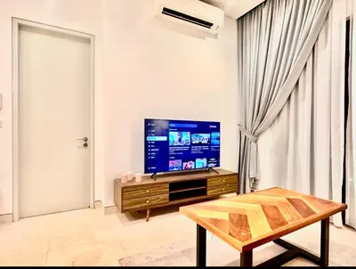 a living room with a tv and a table at Luxurious Home Smart service Lucentia residence in Kuala Lumpur