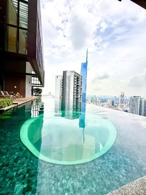 a swimming pool on top of a building with a city at Luxurious Home Smart service Lucentia residence in Kuala Lumpur
