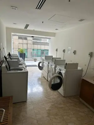 a laundry room with washers and dryers in a building at KLCC Room in Kuala Lumpur
