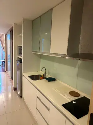 a kitchen with white cabinets and a sink at KLCC Room in Kuala Lumpur