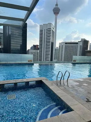 a swimming pool with a view of a city at KLCC Room in Kuala Lumpur