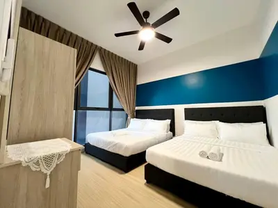 a bedroom with two beds and a ceiling fan at ContiNeW Pudu nr Ikea Cheras 2Br-6pax-1park-Wi-fi in Kuala Lumpur