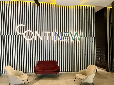 a store lobby with a red couch and two chairs at ContiNeW Pudu nr Ikea Cheras 2Br-6pax-1park-Wi-fi in Kuala Lumpur