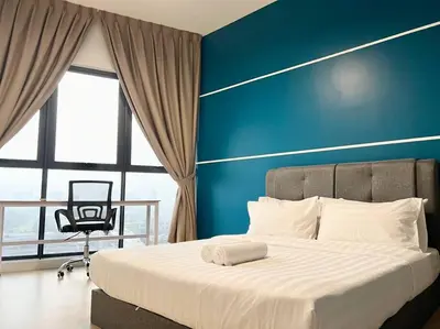 a bedroom with a large bed with a blue wall at ContiNeW Pudu nr Ikea Cheras 2Br-6pax-1park-Wi-fi in Kuala Lumpur