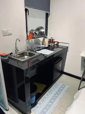 a kitchen counter with a sink in a room at Neu suites 001 cozy studio klcc in Kuala Lumpur