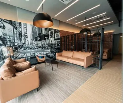 a living room with two couches and a painting of a city at Neu suites 001 cozy studio klcc in Kuala Lumpur