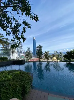 a large swimming pool with a tall building in the background at CONTINEW Residence - TRX KL in Kuala Lumpur