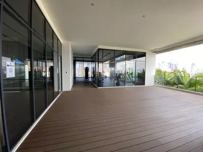 an empty hallway of a building with glass windows at CONTINEW Residence - TRX KL in Kuala Lumpur