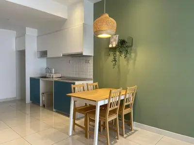 a kitchen with a wooden table and chairs at CONTINEW Residence - TRX KL in Kuala Lumpur