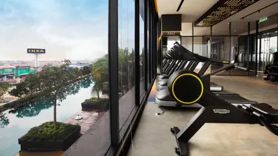 a fitness room with a view of a river at CONTINEW Residence - TRX KL in Kuala Lumpur